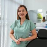 A happy, smiling oral surgery assistant