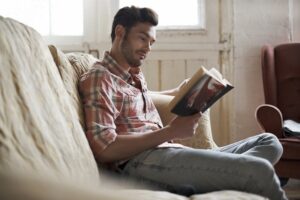 A dental implant patient resting and reading after surgery