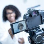 A woman presenting to a video camera