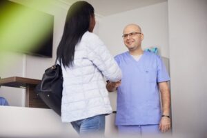 A doctor speaking with a patient to maintain relationship